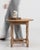 A 20th century French side table crafted in oak, featuring a compact square top supported by a solid frame. The design is...