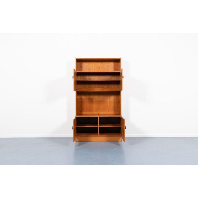 Teak veneer two piece cabinet/bookshelf produced in 1970s, Denmark. Each module features 2 doors with shelves. Versatile...
