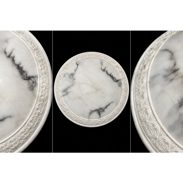 A refined round ceiling light fixture with a 12 inch featuring a soft white glass surface with natural gray veining and an...