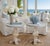 Pair of round side tables featuring intricate hand-applied inlay tops and coordinating apron details. Raised on...