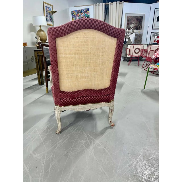 A beautiful 19th century Louis XV Bergere upholstered in cotton velvet check and woven grasscloth. The painted surfaces...