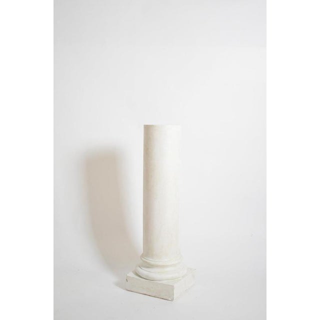 Pair of neoclassical plaster columns, 1930s. Height: 121 cm - 47.64 in Length: 39 cm - 15.35 in Width: 39 cm - 15.35 in