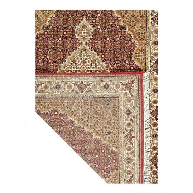 This is a hand-knotted Tabriz Design rug that features a fine, pure, lamb's wool and silk. Each rug has a dense, soft pile...