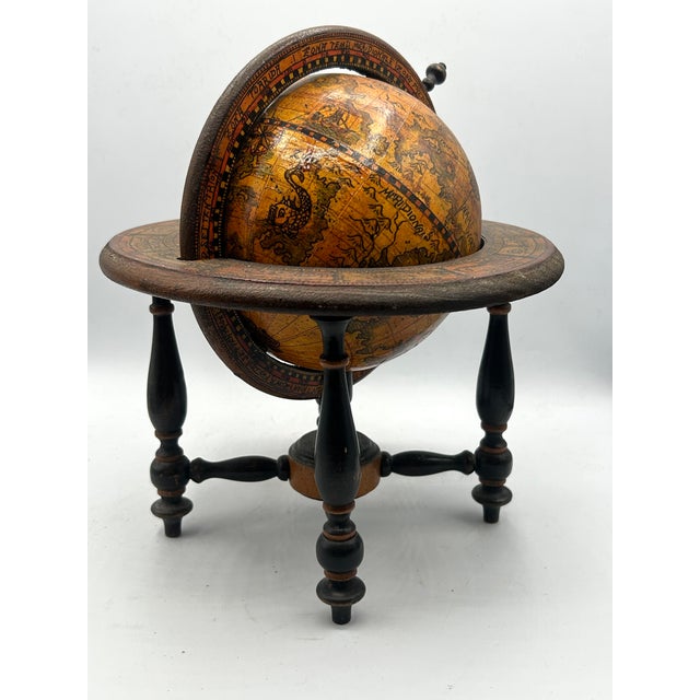 Vintage Italian desk globe featuring antique-style cartography, sailing ships, compass roses, and hand-colored detailing....