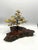 A mid-century tabletop bonsai sculpture featuring dark, gnarled bronze branches and richly textured gilt foliage, mounted...