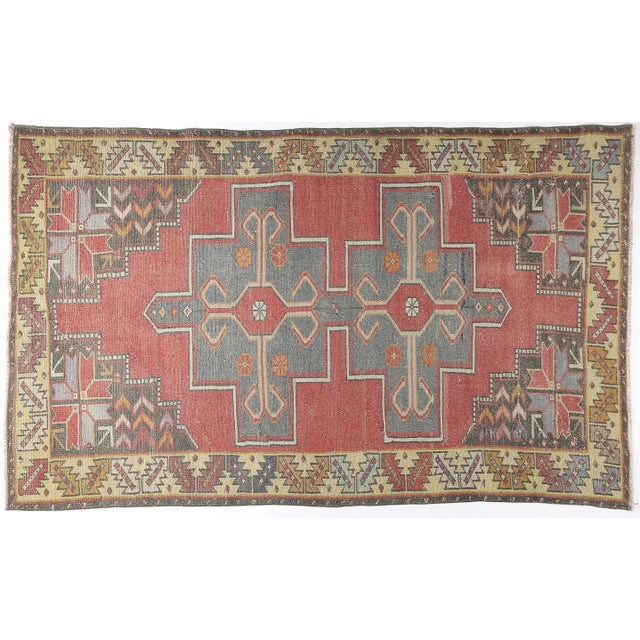This striking vintage Anatolian tribal rug showcases a bold stepped medallion composition, reflecting the timeless weaving...