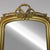 Louis Philippe style gilt mirror, adorned with a pretty ribbon trim. The mirror is original.