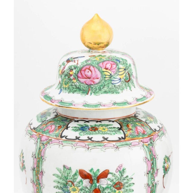 Pair of Floral Painted Porcelain Covered Urns, marked "Japanese Porcelain Ware / Decorated in Hong Kong" to underside....