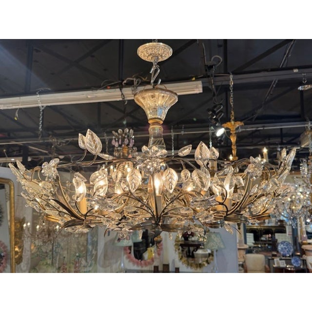 The French Maison Bagues Gilt Tole and Crystal Flower Chandelier is a modern and elegant lighting fixture that features a...