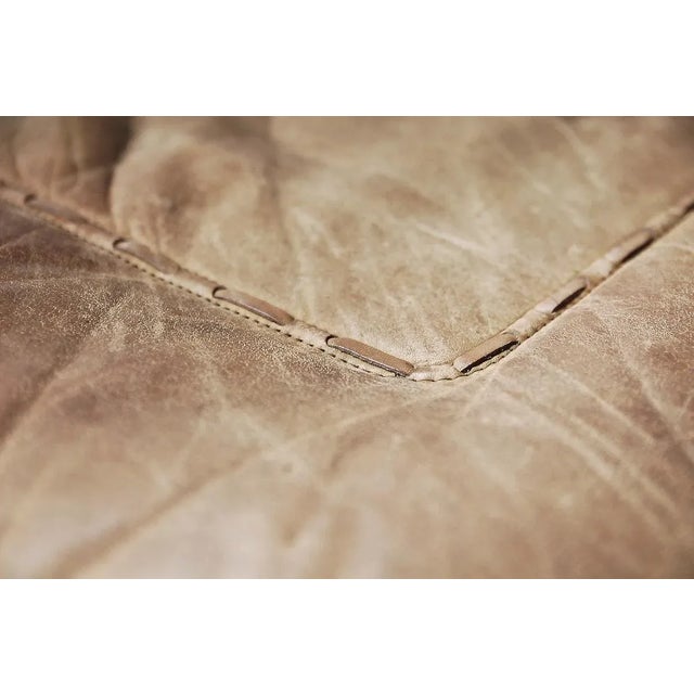 This pair of leather lounge armchair was created by Carl Straub during the 1950s. This swivel chairs are upholstered in...