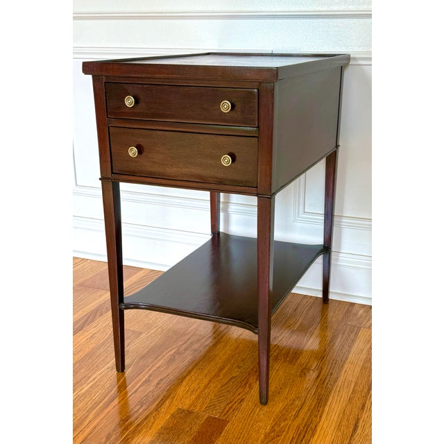 This vintage mahogany side table was produced by Imperial Furniture of Grand Rapids, Michigan, and features a leather...
