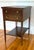 This vintage mahogany side table was produced by Imperial Furniture of Grand Rapids, Michigan, and features a leather...