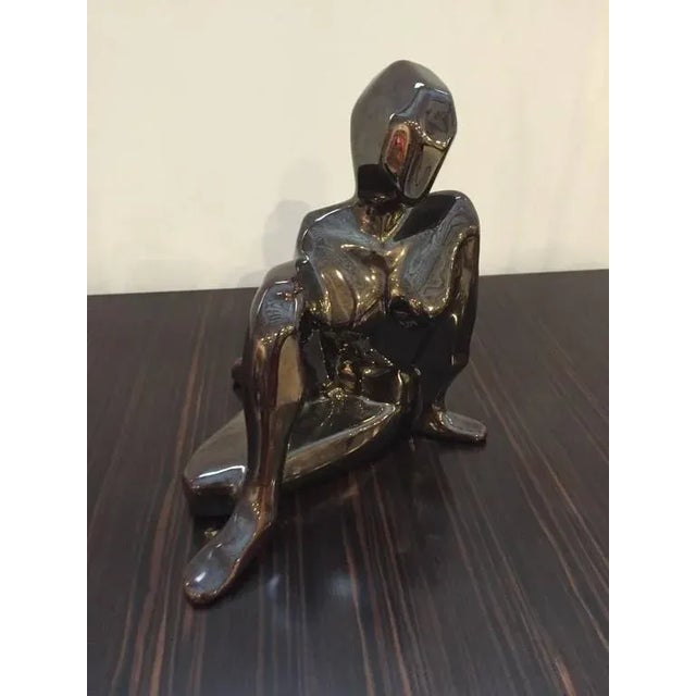 A very cute "cubist" sculpture in metallic color. Great for a coffee table or on your desk. Adds a very nice touch to your...