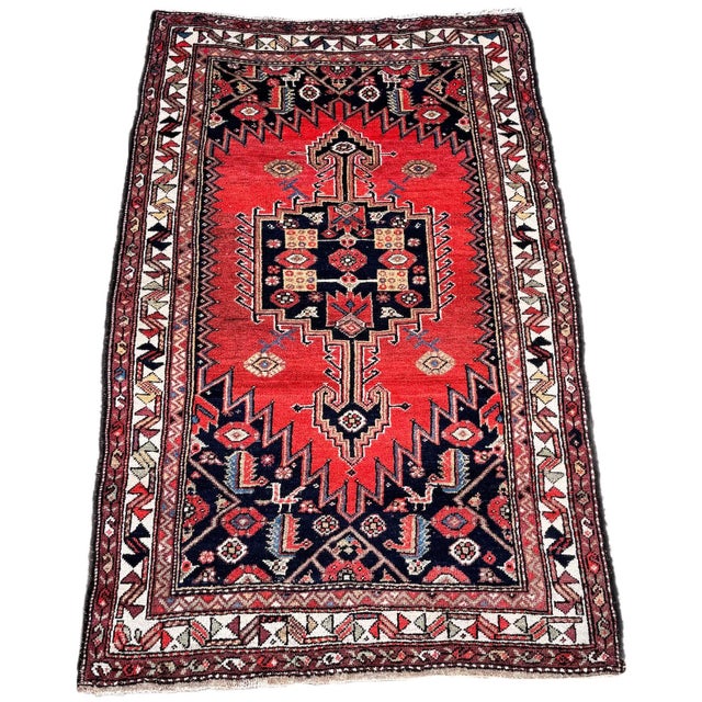 A lovely antique tribal rug, woven by the Lors tribe circa 1920. The design features a single geometrical medallion on a...