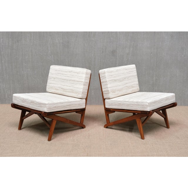 This striking pair of lounge/slipper chairs was produced in Denmark in the 1950s. The design is defined by its dynamic,...