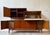 Stunning walnut modular sideboard bar cabinet. This super rare one piece unit offers a ton of storage space and is in...