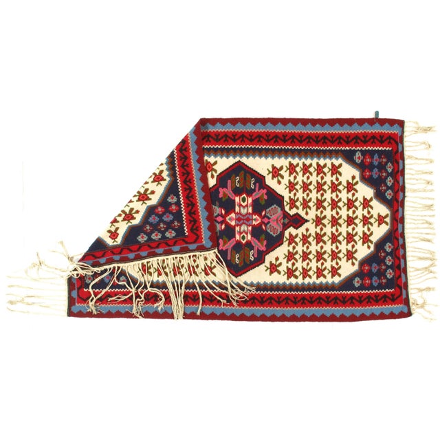 This is a Persian kilim. The piece was hand-woven using hand-spun lamb's wool. The piece is vegetable dyed.