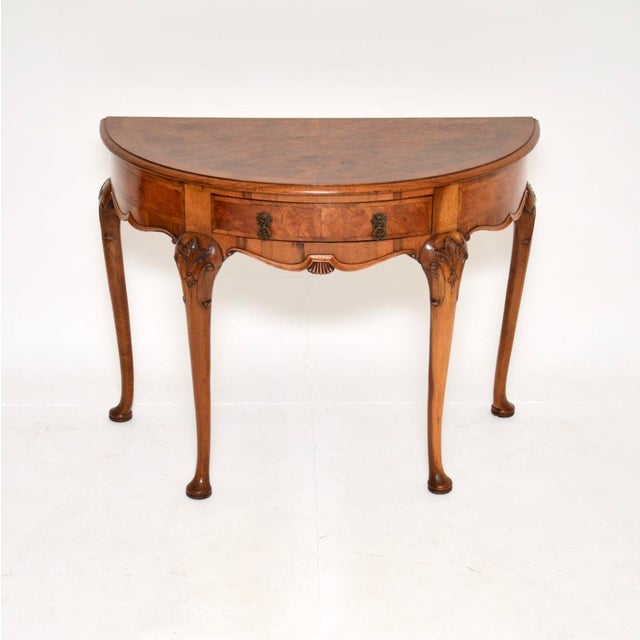 A stunning antique burr walnut console table, made in England and dating from around the 1900-1910 period. It is of...
