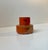 A small high fired stoneware vase executed with reddish orange glazes with earthy/black accents. Unknown Scandinavian...