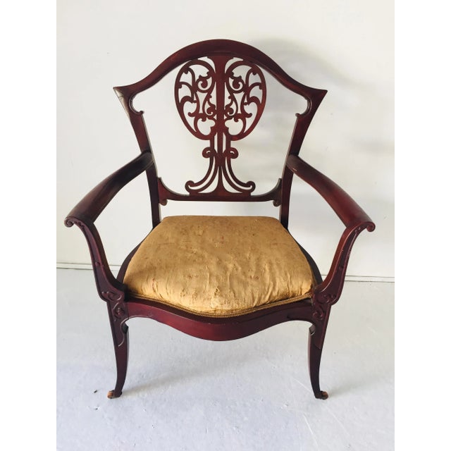 Antique Art Nouveau Arm Chair Mahogany, needs re-upholstery and wood repair on reverse of solar (shown). We deliver within...