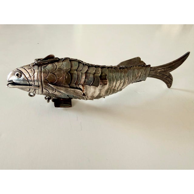 A stunning and rare antique Judaica spice box (besamim) in the form of a fully articulated silver fish. The craftsmanship...