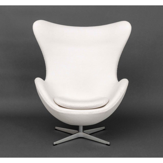 Fritz Hansen White Upholstered Egg Chair, label to seat. 31" H x 34" W x 27" D; seat: 14.5" H. Provenance: From a One...