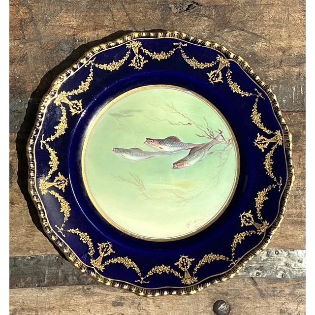 Capture the essence of Victorian luxury with this rare, complete set of 12 hand-painted fish plates by the renowned...