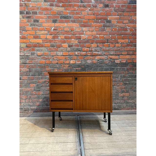 Scandinavian-style piece of furniture dating from the 1960s. It has four functional drawers and a door opening onto a...