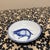 This charming, small ceramic dish features a classic hand-painted koi carp design in a deep cobalt blue against a crisp...
