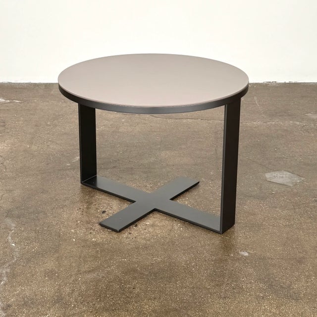 This sturdy side table with chunky cross base and contrasting finishes is a perfect fit between 2 chairs or next to a...
