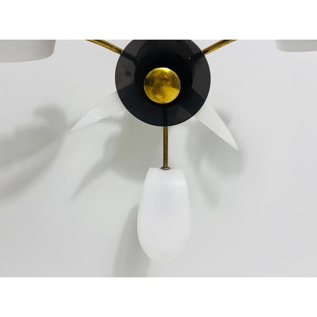 This Italian Sputnik ceiling lamp from the 1950s is a captivating example of mid-century modern design in the style of...