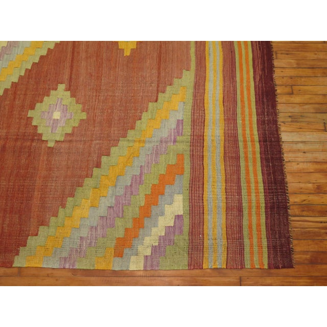 A room size mid-20th century Turkish Kilim flat-weave with pretty accents in lavender, blue-gray, yellow and soft green on...