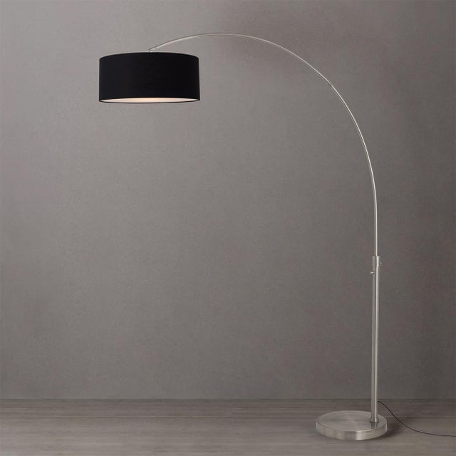 The Float Arc Lamp is a Modern arc lamp designed by Peter Morelli in 1960, featuring a satin nickel steel body and a black...