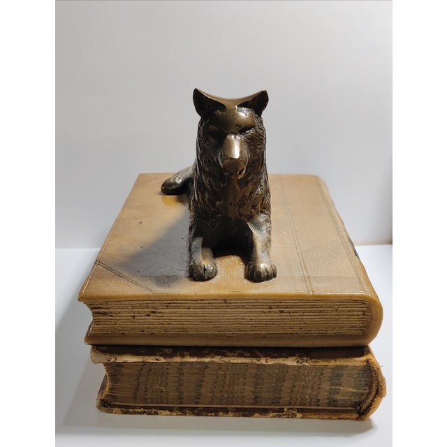 For your consideration . . . A vintage bronze sculpture design of a wolf lying on the top of a faux leather book. The...