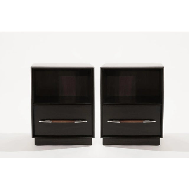 Set of nightstands designed by T.H. Robsjohn-Gibbings for Widdicomb, circa 1950-1959. Executed in walnut, completely...