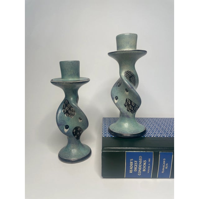 This pair of African soapstone candlesticks could be transitional from either a Boho chic to tribal style setting. The...