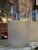 A pair of elegant frosted glass cylinder lamps featuring a minimalist, modern design. Each piece showcases a smooth...