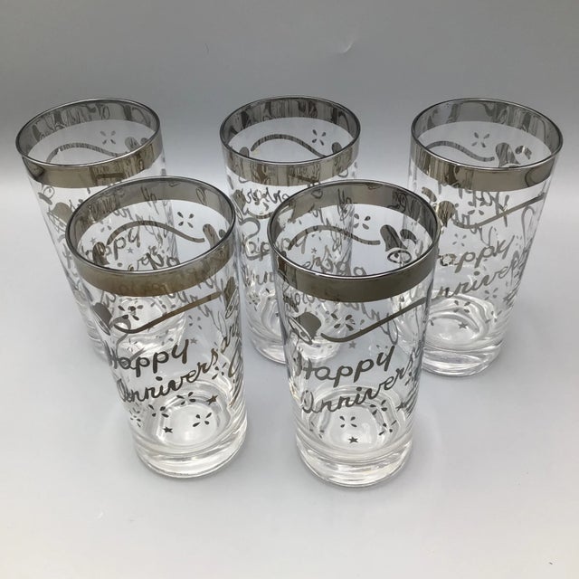 This is a beautiful set of 5 high ball glasses with platinum rim and “Happy Anniversary” . These glasses are perfect for a...