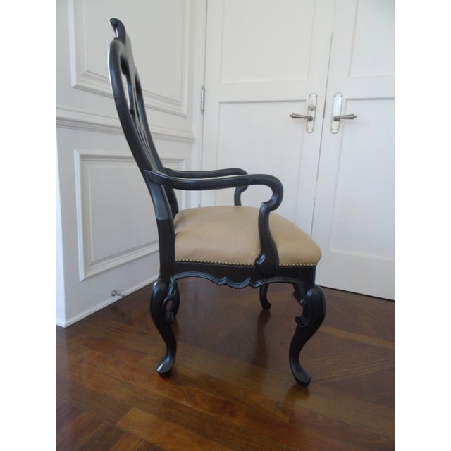 A Great elongated and tan leather with nailhead trim upholstered chair. Perfect for a desk or writing table or just as a...