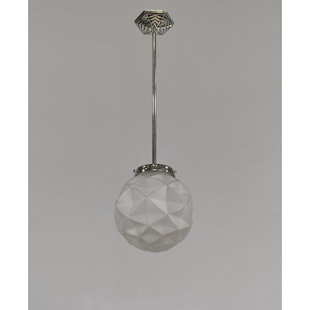 Degué A French 1925-1935 art deco pendant light Suspended from a single, elegant nickel-plated brass rod. It holds a nice...