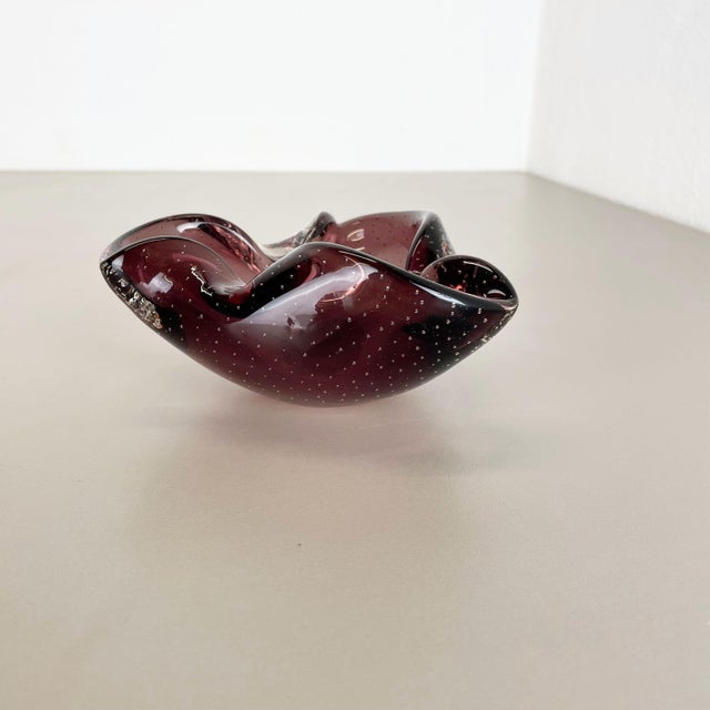 Article: Murano glass bowl, ashtray element Origin: Murano, Italy Decade: 1970s This original glass shell bowl was...
