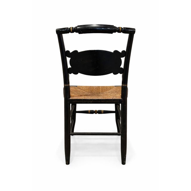 A beautifully detailed vintage Hitchcock armchair featuring the brand’s iconic black lacquer finish with hand-applied gold...