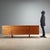 1980s walnut veneered sideboard, featuring a spacious and functional design. The side-hinged doors offer ample storage...
