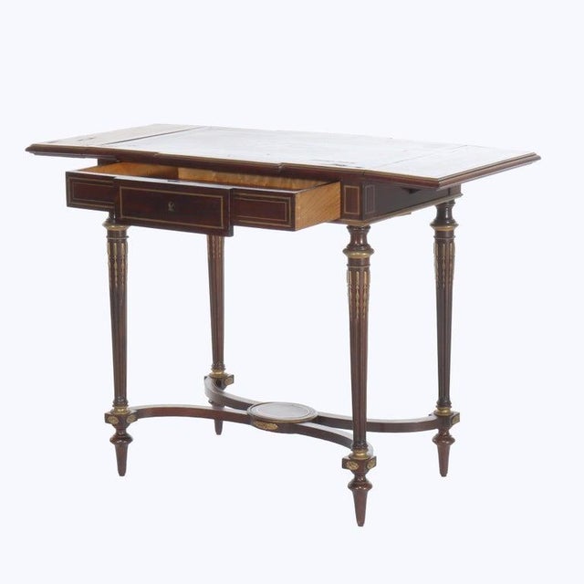 A refined 19th-century lady's drop-leaf desk, attributed to the esteemed French ébéniste François Linke, exemplifies the...