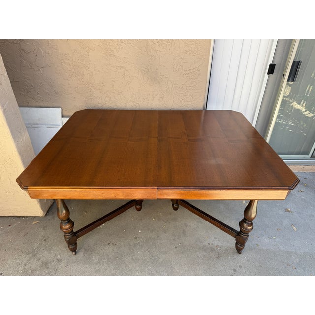Beautiful vintage English Jacobean Revival draw-leaf dining table featuring turned legs, decorative stretcher base, and...