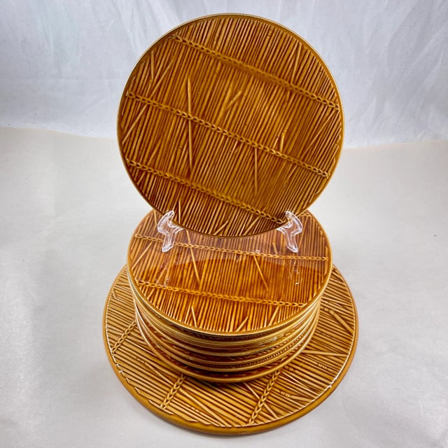 From Gien, a straw pattern cheese service, a server and eight plates, France, circa 1950s. The Trompe l’oeil pattern has a...