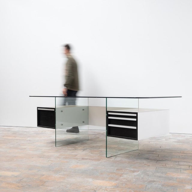 Large executive desk by Xavier Marbot - 1960 Veneered cabinet suspended by a detachable glass base Smoked glass top. *...