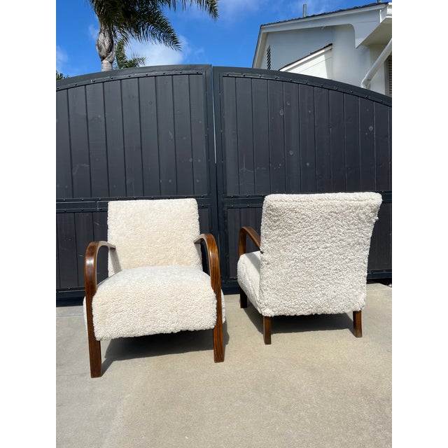 Pair of Danish 1940s lounge chairs by famed furniture designer Fritz Hansen. Newly upholstered in genuine shearling...