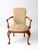 This is an antique Queen Anne style upholstered arm chair. Featuring classic cabriole legs, open arms, and a gold and...