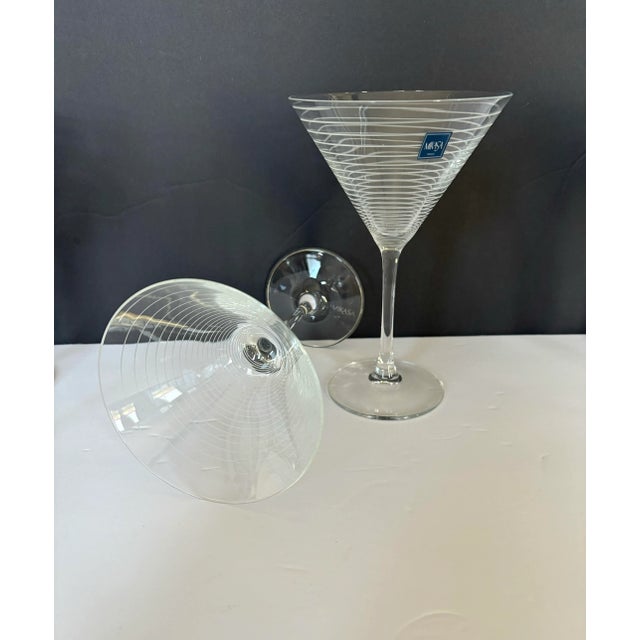 A sophisticated pair of Mikasa martini glasses featuring a horizontal etched ring design that subtly encircles the bowl....